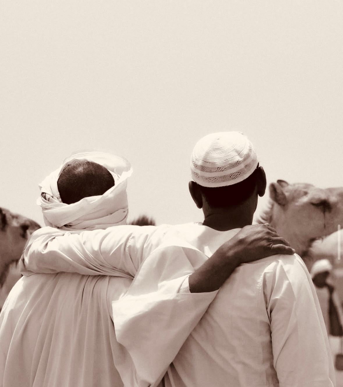 Two men embracing, standing together in solidarity